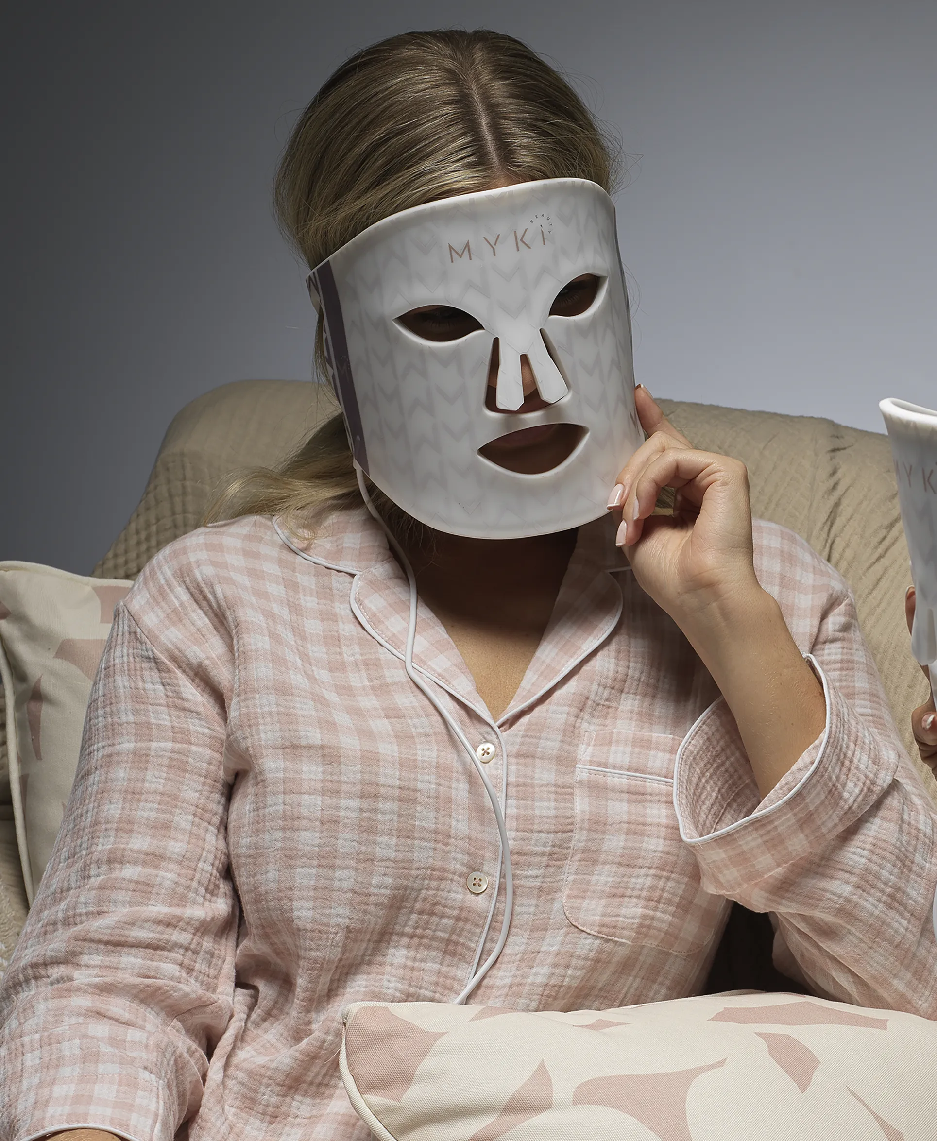 putting on a MyKi Beauty led face mask