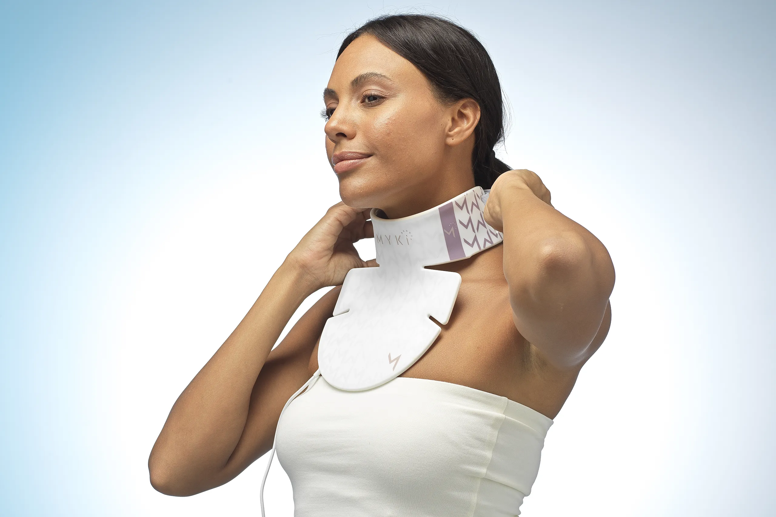 MyKi neck mask being put on with adjustable straps